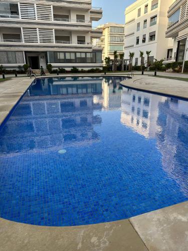 a large blue swimming pool in a building at AppartementBijou in Pont Blondin