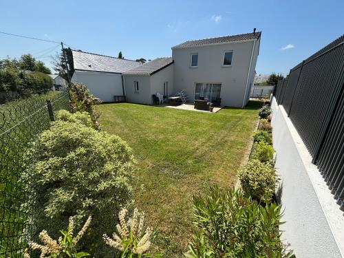 a backyard of a house with a fence at Les maisons Inael in Pénestin