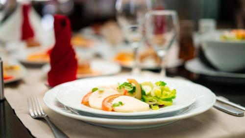 a plate of food on a table with a glass at Palais Du Desert Hotel & Spa in Erfoud