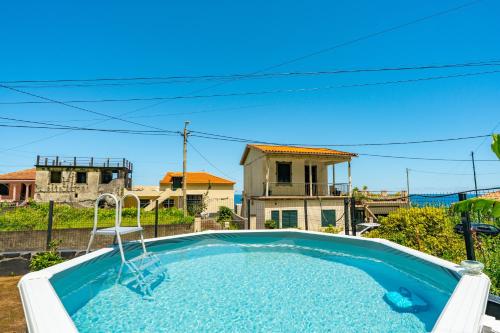 a swimming pool in the backyard of a house at Fajã Lodges - House Ash in São Vicente