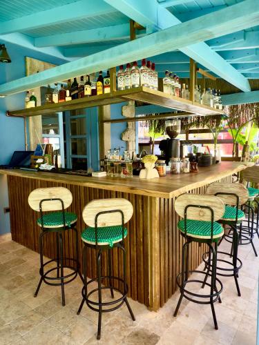 a bar with green stools in a restaurant at Banana Alaçatı Food & Stay - Adults Only in Alacati