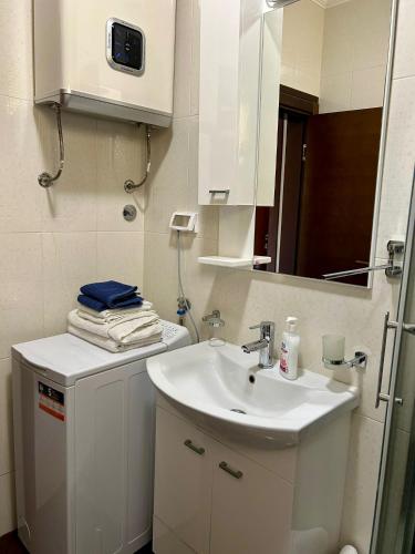 a white bathroom with a sink and a mirror at Casablanca in Sutomore