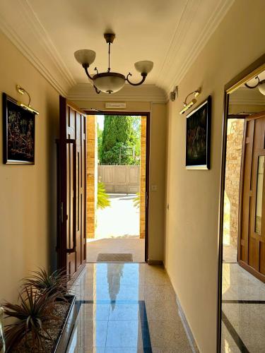 a hallway of a house with a chandelier at Casablanca in Sutomore