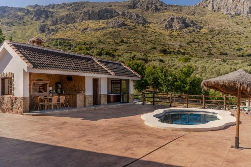 a villa with a swimming pool and a house at Casa Chely in Alcaucín