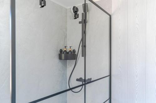 a shower with a glass door in a bathroom at Casa Chely in Alcaucín