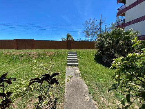 a garden with a path in the grass at SA · Beachfront Saquarema: Your beach house! in Saquarema