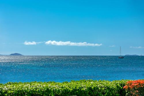 a view of the ocean with a boat in the water at Maalaea Banyans 102 by Coldwell Banker Island Vacations in Wailuku