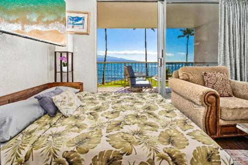 a bedroom with a bed and a view of the ocean at Maalaea Kai 215 by Coldwell Banker Island Vacations in Wailuku