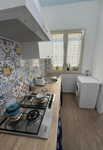 a kitchen with a stove and a sink in it at Casa del Pescatore in Trappeto
