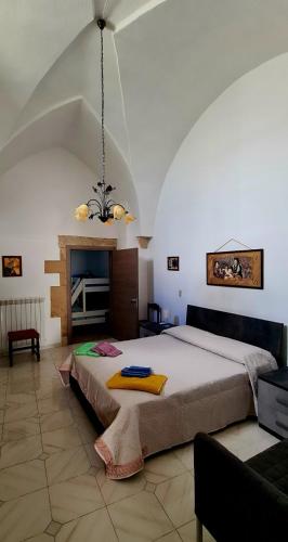 a bedroom with a large bed and a fireplace at Via Cufra 46 in Botrugno