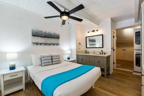 a bedroom with a bed with a ceiling fan at Maalaea Banyans 416 by Coldwell Banker Island Vacations in Wailuku