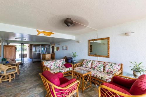 a living room with couches and chairs and a mirror at Maalaea Banyans 416 by Coldwell Banker Island Vacations in Wailuku