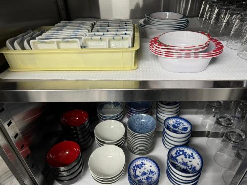 a drawer full of plates and bowls in a refrigerator at 波のたわむれ in Kami Amakusa