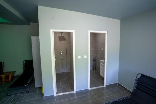 a bathroom with a shower and a toilet in a room at Vila Jasen - Bjelašnica in Sarajevo