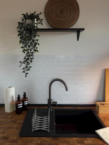 a kitchen sink with a faucet on a counter at Fernblick - Ferienwohnung mit Bastei-Aussicht in Kurort Rathen