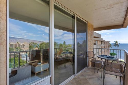 a balcony with a view of the ocean at Nani Kai Hale 604 by Coldwell Banker Island Vacations in Kihei