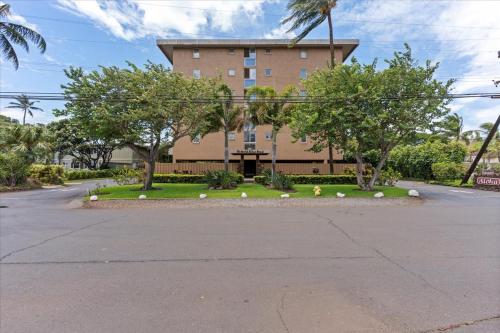 a large building with trees in front of it at Nani Kai Hale 604 by Coldwell Banker Island Vacations in Kihei
