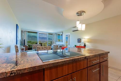 a kitchen with a large island with a counter top at Nani Kai Hale 502 by Coldwell Banker Island Vacations in Kihei
