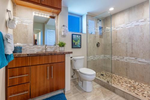 a bathroom with a toilet and a glass shower at Nani Kai Hale 502 by Coldwell Banker Island Vacations in Kihei