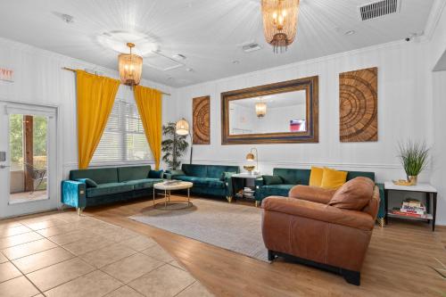 a living room with green couches and a mirror at Banana Leaf Villa in Orlando