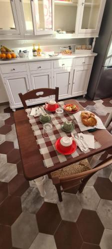 a kitchen with a table with food on it at La casa di nonno in Ghilarza