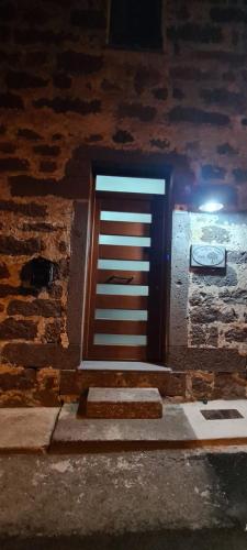 a door in a brick wall with stairs in front at La casa di nonno in Ghilarza