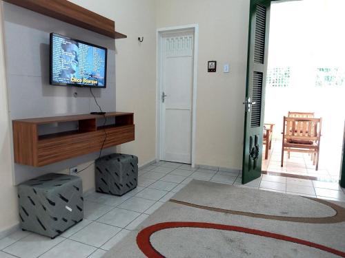 a living room with a flat screen tv on a wall at Casa Verde Marinho - Sossego no Jacarecanga in Fortaleza