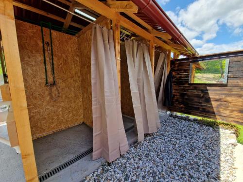 a house being constructed with curtains on the outside at Mountain Camp Outdoor Tara in Tjentište