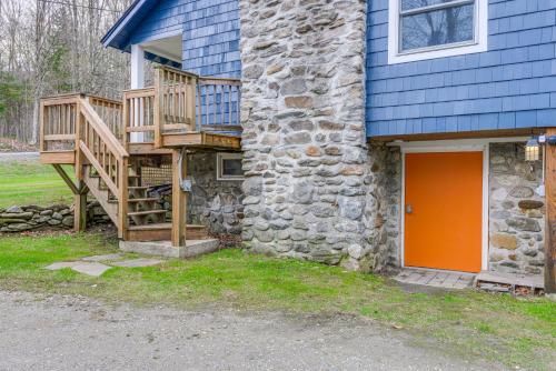 a house with a wooden deck next to a building at Home 2 Mi to Mt Snow Ski, Fish and Hike! in Wardsboro