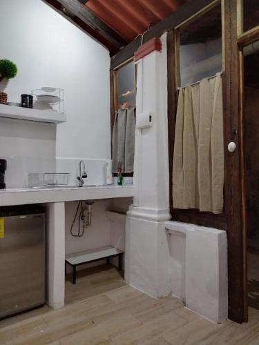 a white bathroom with a sink and a toilet at Casa en el Centro de Taxco in Taxco de Alarcón