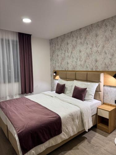 a bedroom with a large bed in a room at Alegria Rooms Sarajevo in Ilijaš