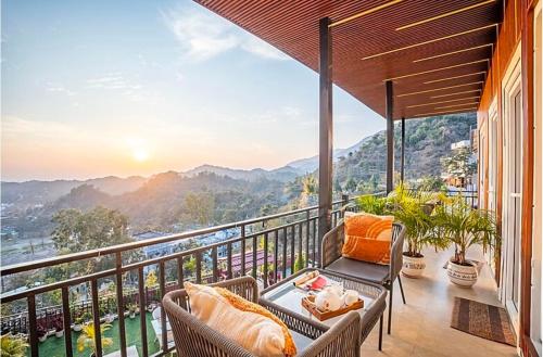 a balcony with a view of the mountains at The Narayana Homestay - Villa in Dehradun