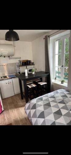 une cuisine avec une table et des chaises dans une pièce dans l'établissement Studio coeur de ville, à Figeac