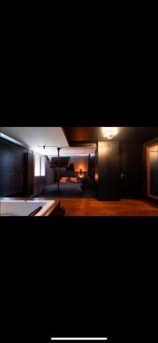a room with a kitchen and a living room at Mirava room in Épône