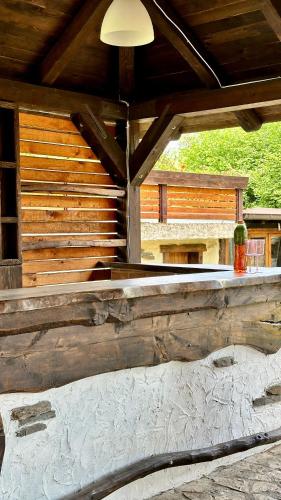 a wooden porch with a bench in front of a building at Vila Aleksić in Smederevo