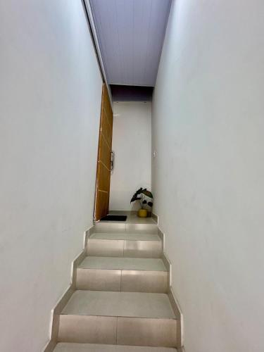 a stairway leading up to a building with a stair case at Studio Rasa Beach: Comfort in the heart of Buzios! in Armacao dos Buzios