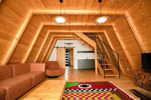 a living room with a couch and a staircase at Kasollet e zanave in Pristina