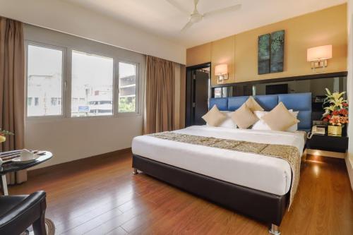 a bedroom with a large bed in a room at Quality Inn Bez Krishnaa in Visakhapatnam