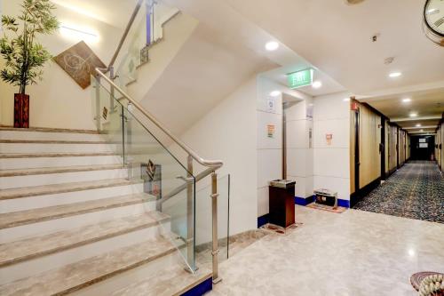 a staircase in a building with a stair case at Quality Inn Bez Krishnaa in Visakhapatnam