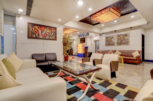 a waiting room with white chairs and a table at Quality Inn Bez Krishnaa in Visakhapatnam