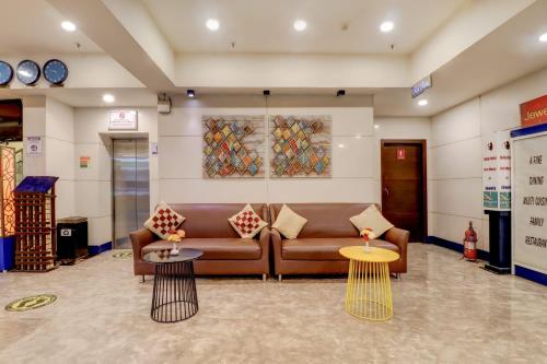 a living room with a couch and two tables at Quality Inn Bez Krishnaa in Visakhapatnam