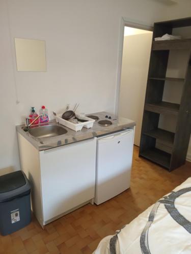 a kitchen with a counter and a sink in a room at Studio annonay in Annonay