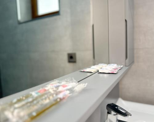 a counter in a bathroom with a mirror at River Garden Gabala -Rooms , Villas in Gabala