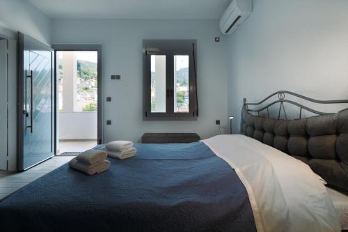 a bedroom with a large bed with two pillows on it at Elymnion Horizon in Limne