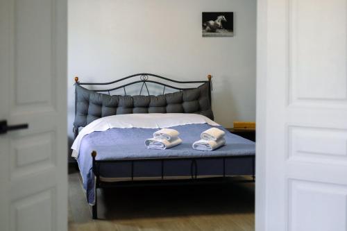 a bedroom with a bed with two shoes on it at Elymnion Horizon in Limne