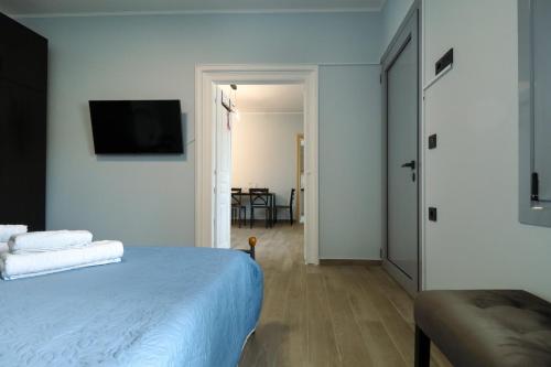 a bedroom with a bed and a television on a wall at Elymnion Horizon in Limne