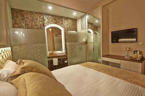 a bedroom with a bed and a bathroom with a sink at Arart Hotel in Istanbul