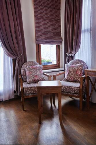 a living room with two chairs and a table and a window at Arart Hotel in Istanbul