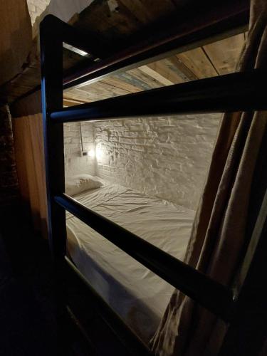 a bunk bed is seen through a window in a room at El Gran Gomero Hostal & Motoposada in Resistencia