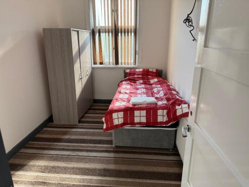 a small bedroom with a bed and a window at Lux spacious 3BR entire apartment in Wakefield